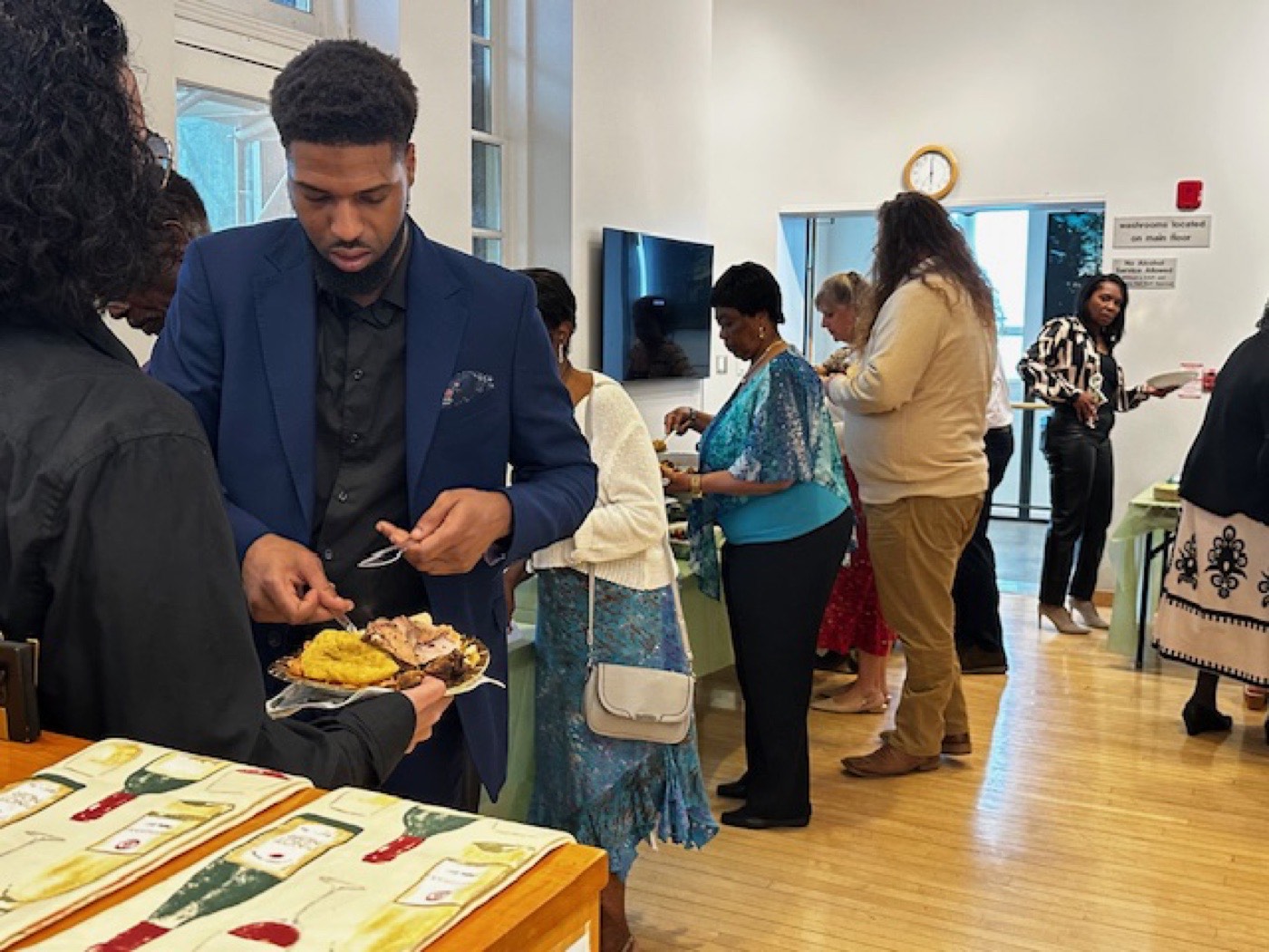 A guest plating food at the buffet line.