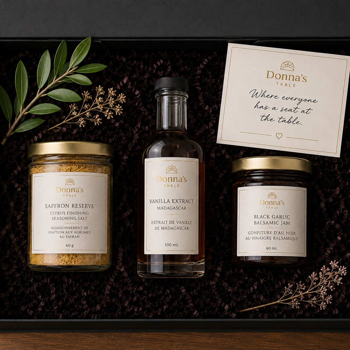 Donna's Table gift box with the full pantry collection nestled in dark crinkle paper.